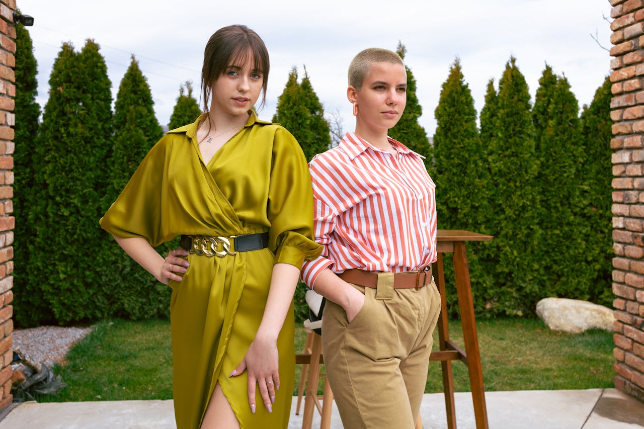 services-03 Two women standing confidently in chic outfits, showcasing modern fashion trends.