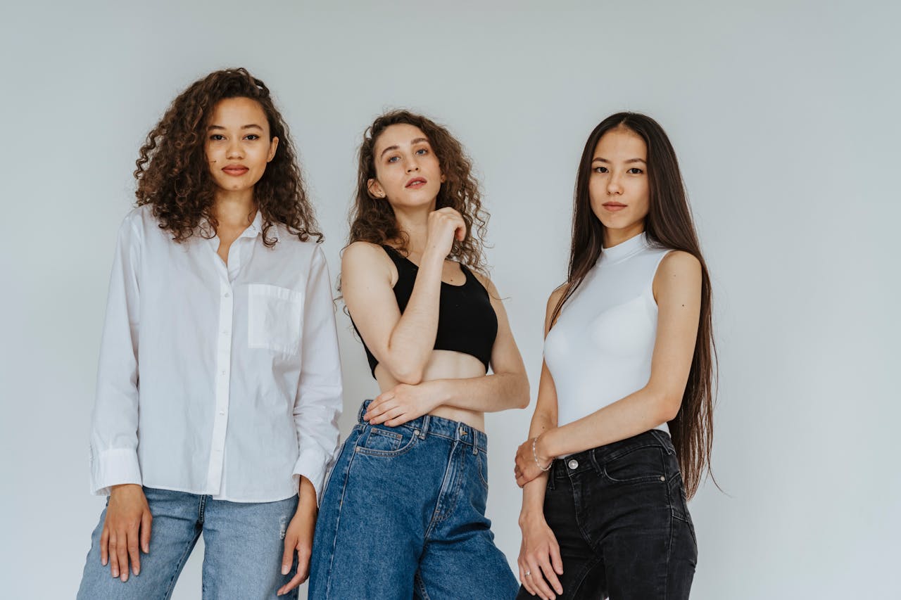 services-04 Trio of diverse women posing in casual denim and stylish tops for a contemporary photoshoot.